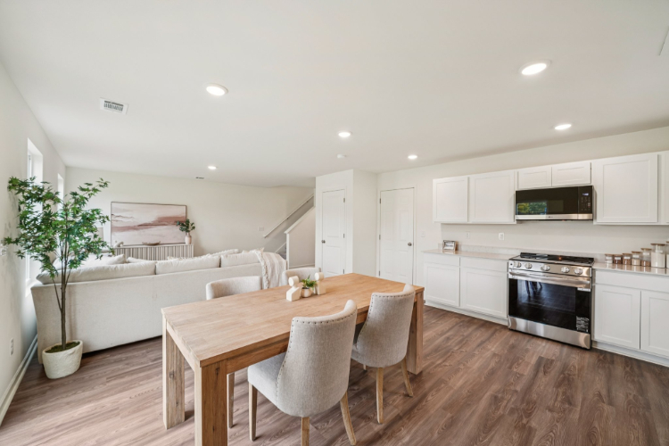 A large kitchen with a dining table.