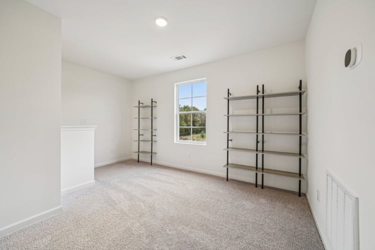 A room with a ladder and a window.