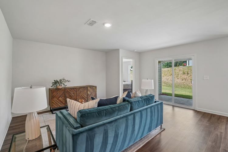 A living room with a blue couch.