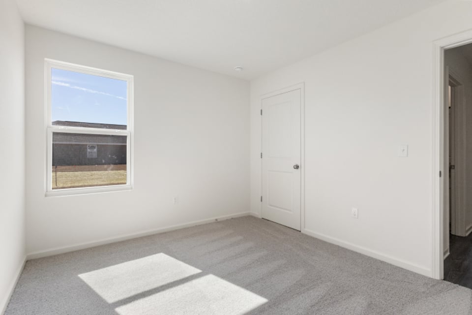 A room with white walls and a window.