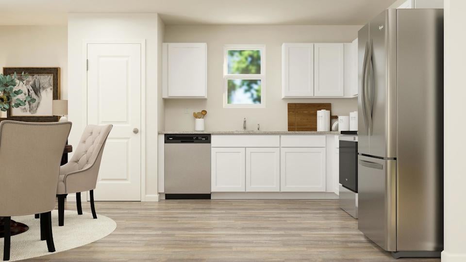 A kitchen with white cabinets.