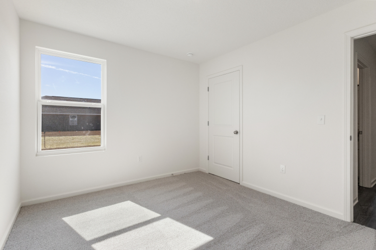 A room with white walls and a window.