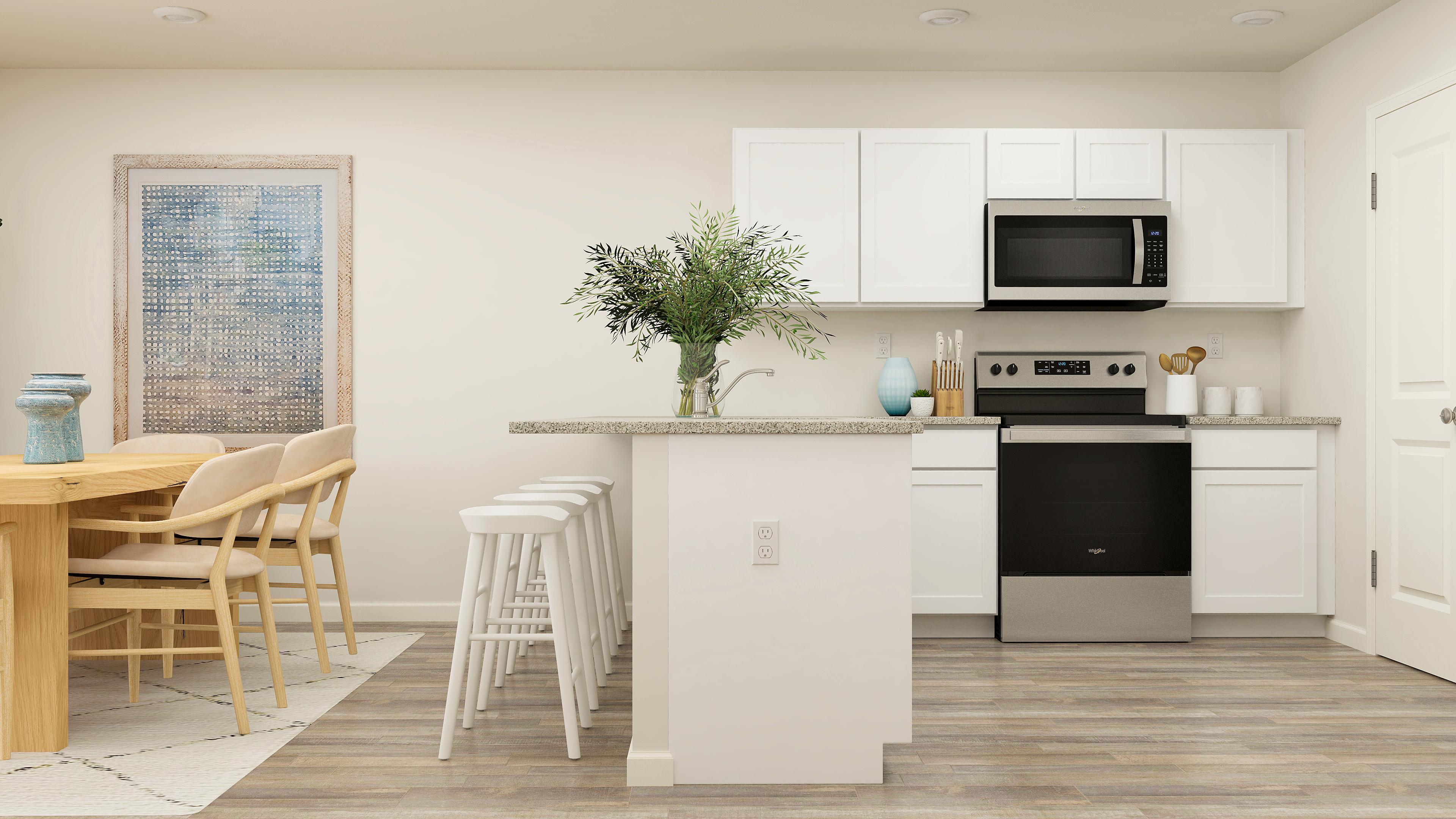 A kitchen with white cabinets.