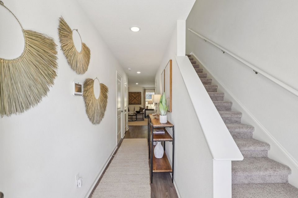 A staircase with a table and chairs.