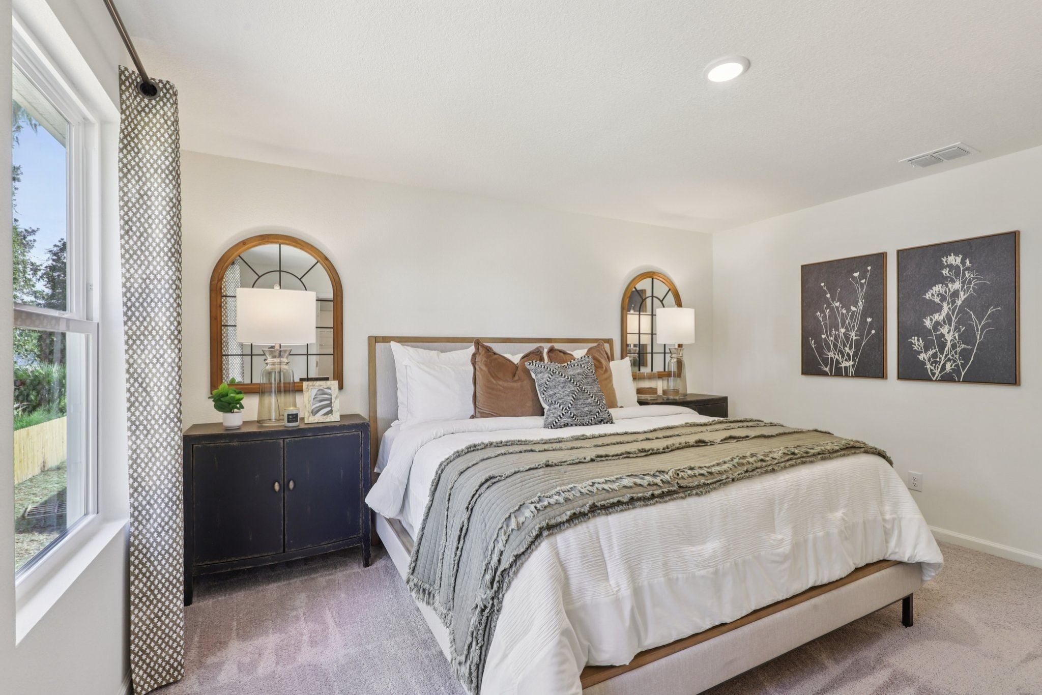 A bedroom with a large mirror.