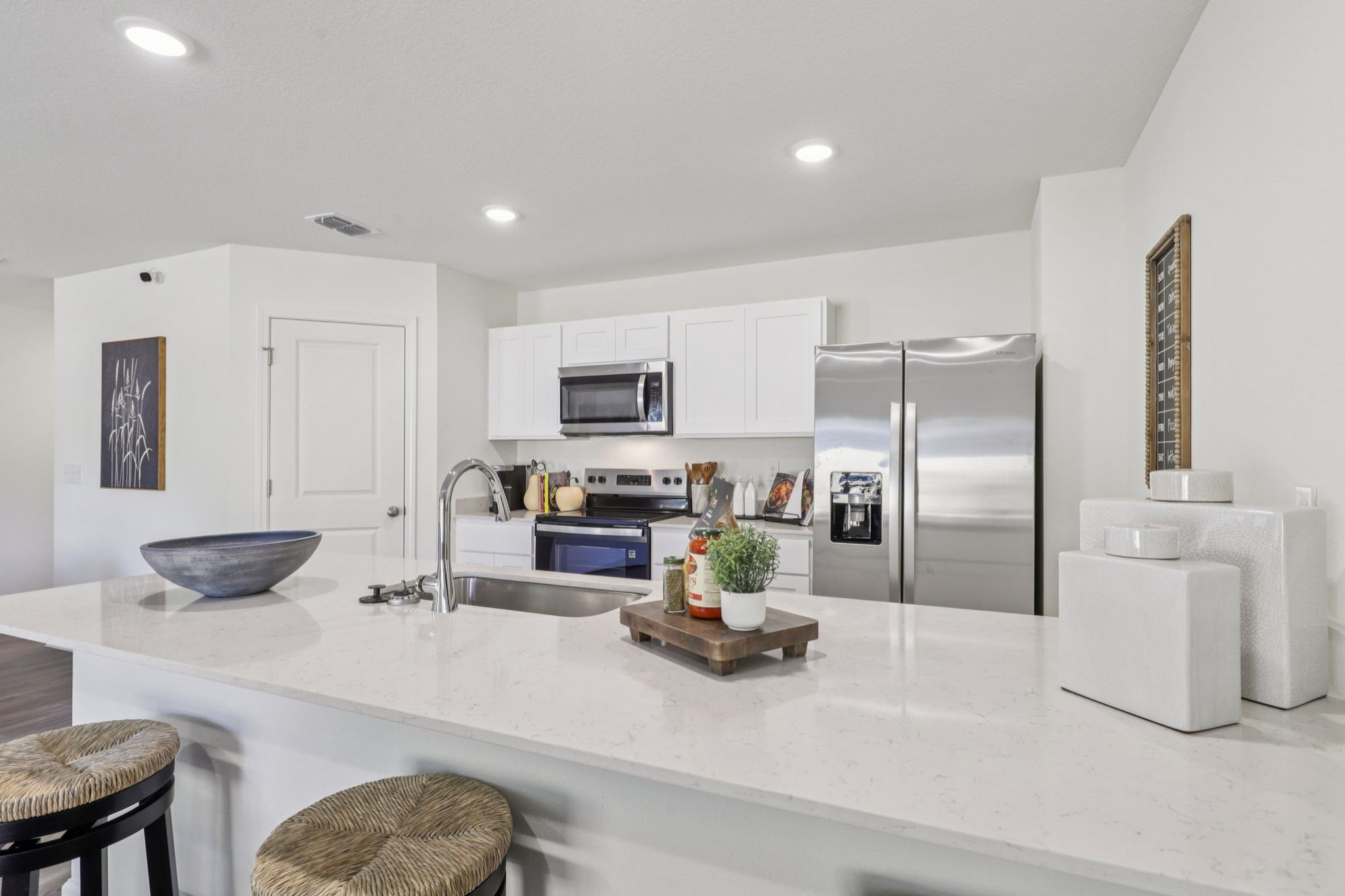 A kitchen with white cabinets.