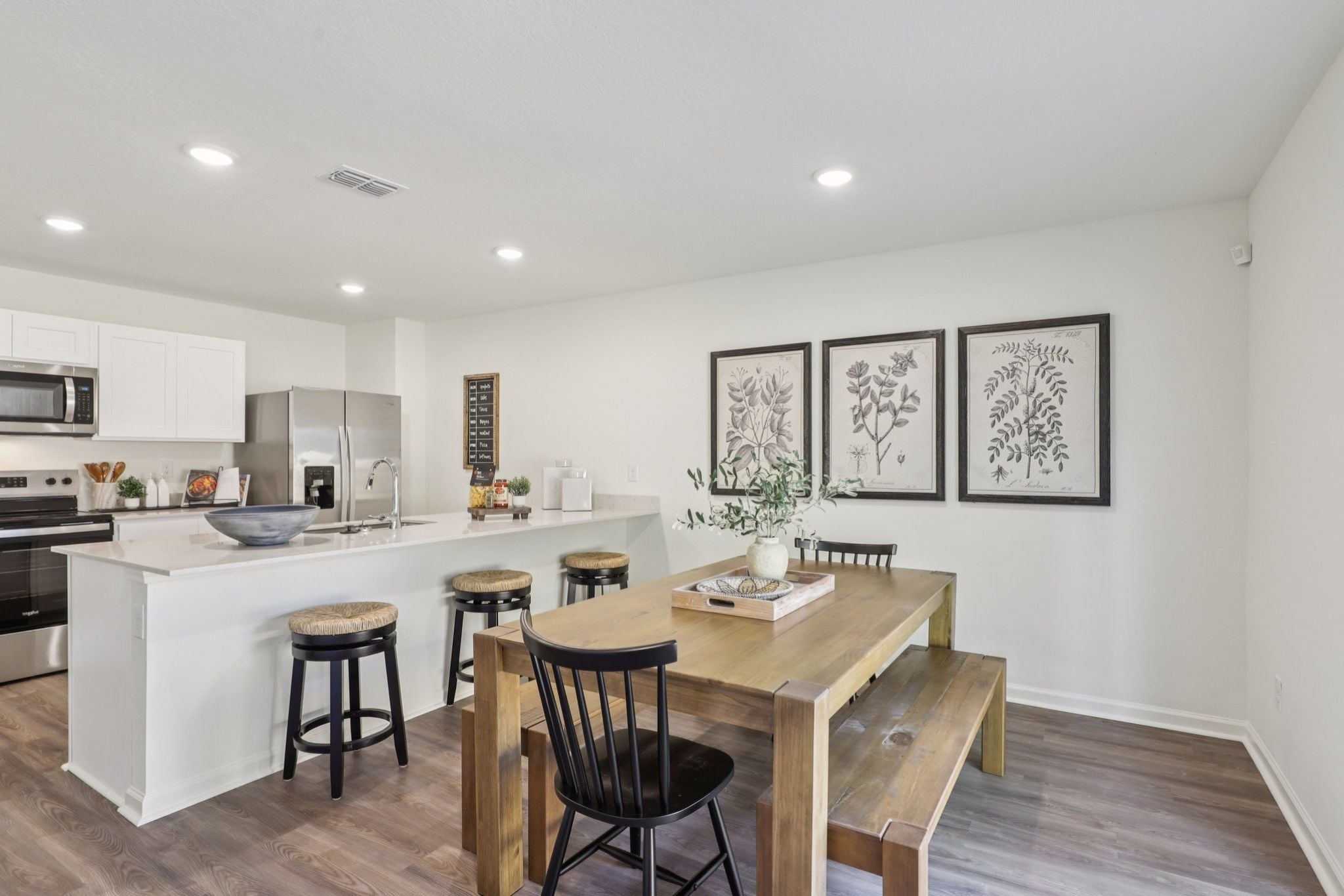 A kitchen with a table and chairs.