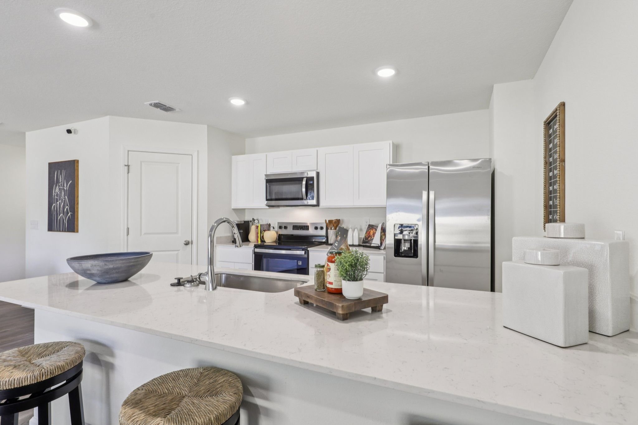 A kitchen with white cabinets.