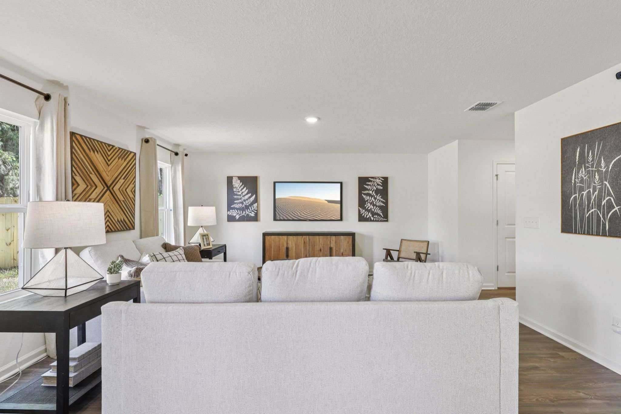 A large white living room with a large white couch.