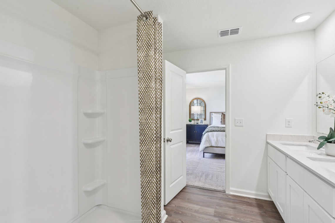 A bathroom with a shower and a sink.