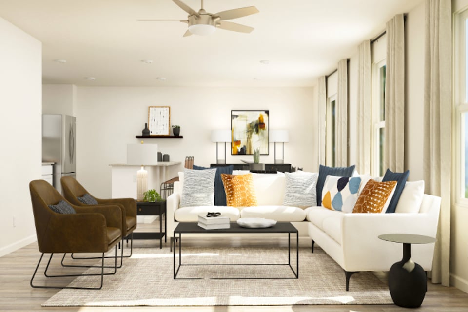 A living room with a white couch and a table.