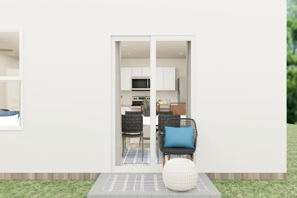 A room with a table chairs and a glass door.