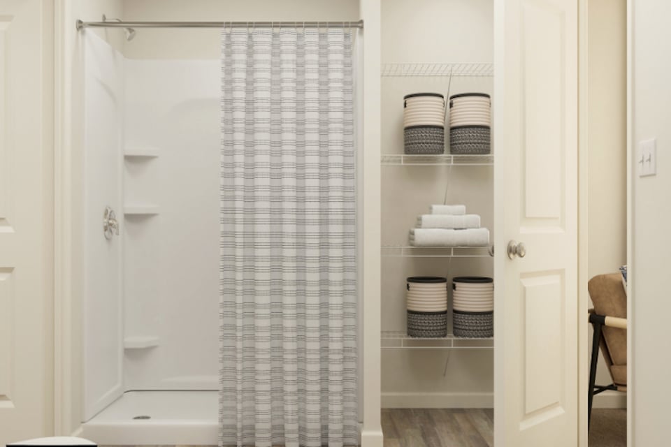 A shower with a glass door.