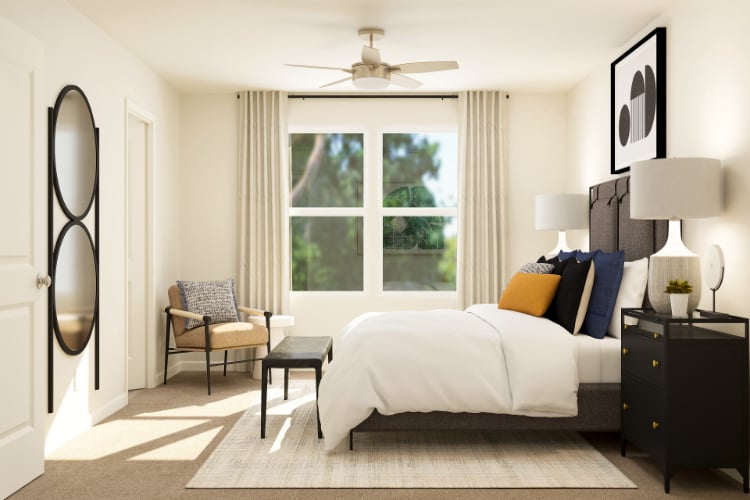 A bedroom with a bed and a fan.