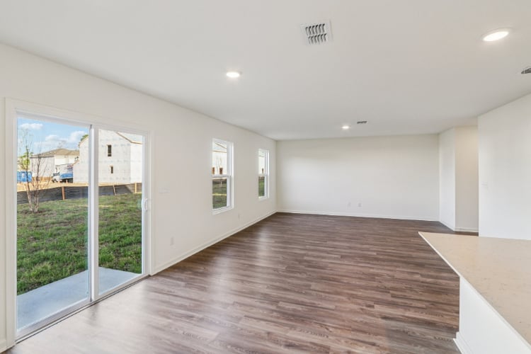 A room with a wood floor and windows.