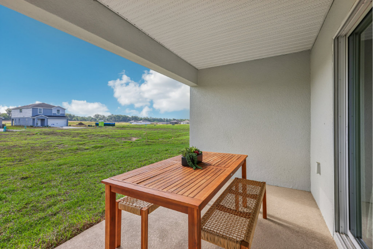 A table and chairs on a deck.