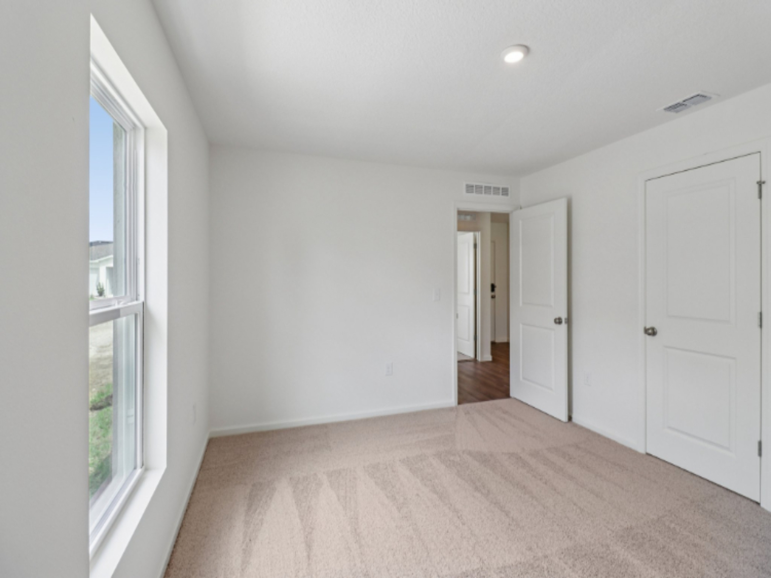 A hallway with white doors.