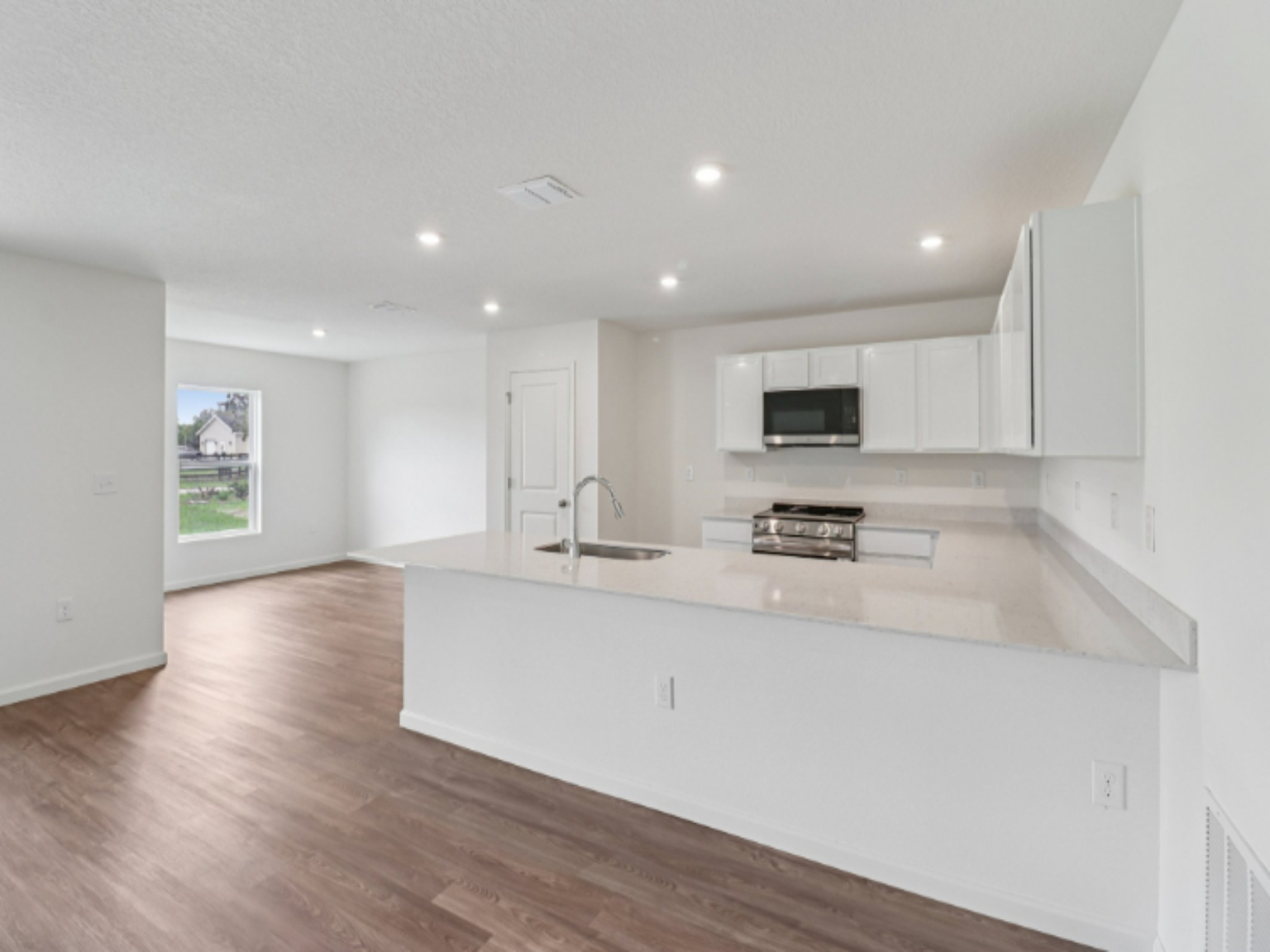 A kitchen with white cabinets.