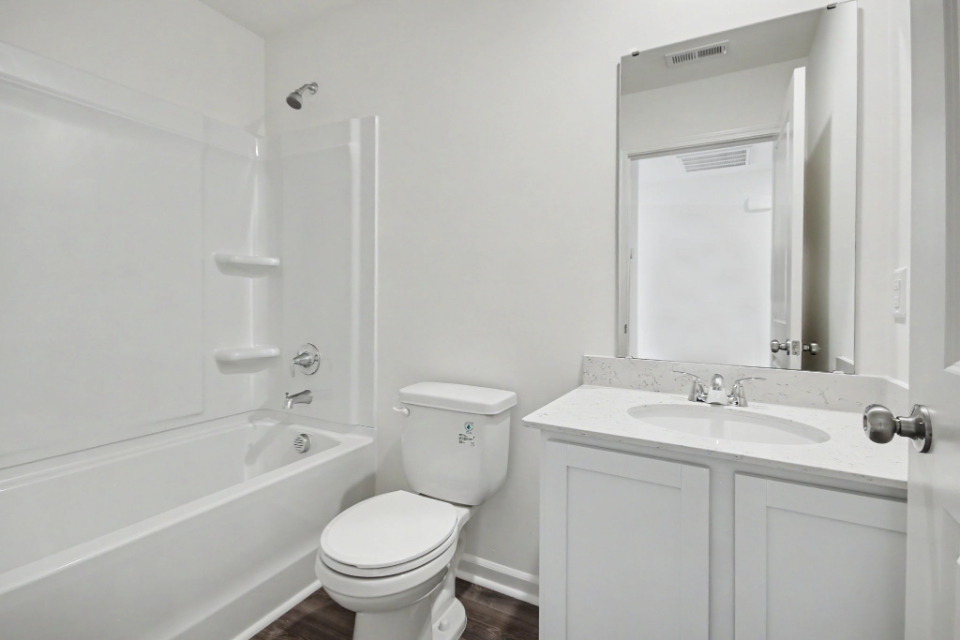 A bathroom with a toilet sink and bathtub.