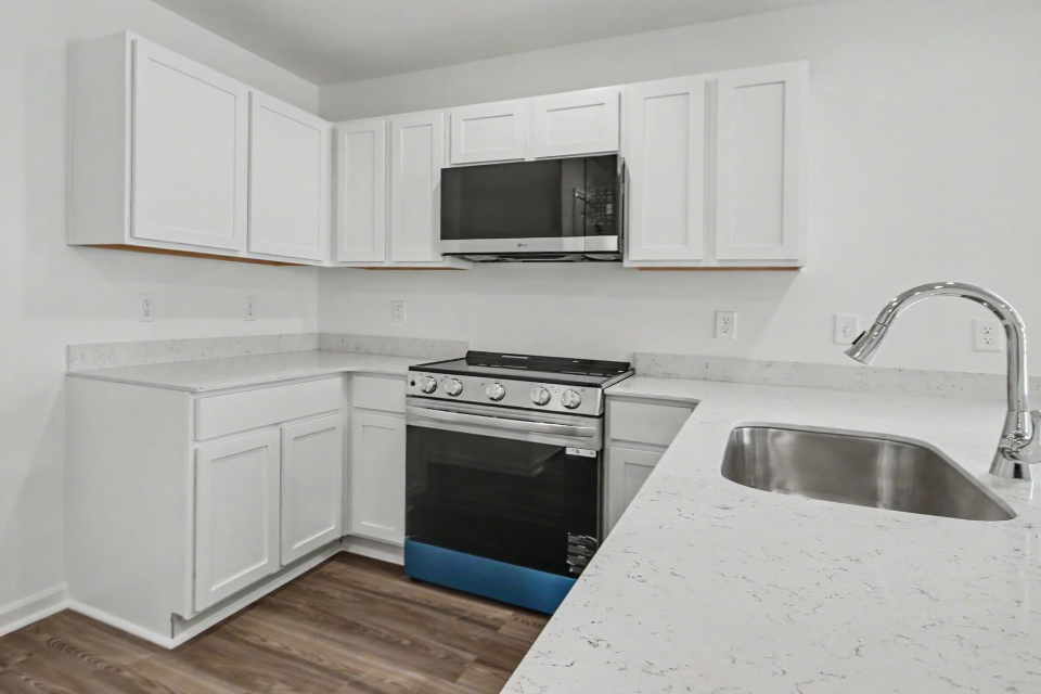 A kitchen with white cabinets.