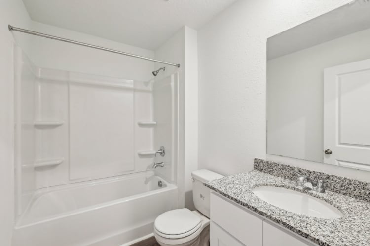 A bathroom with a sink toilet and bathtub.