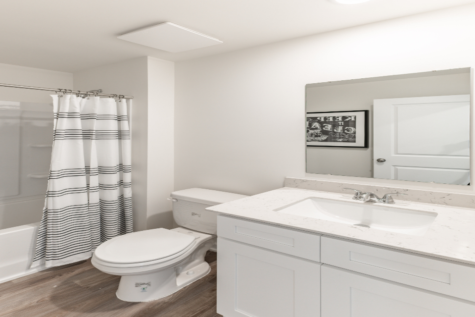 A bathroom with a tub sink and toilet.