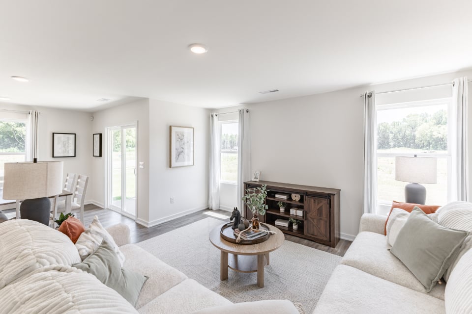 A living room with white furniture.