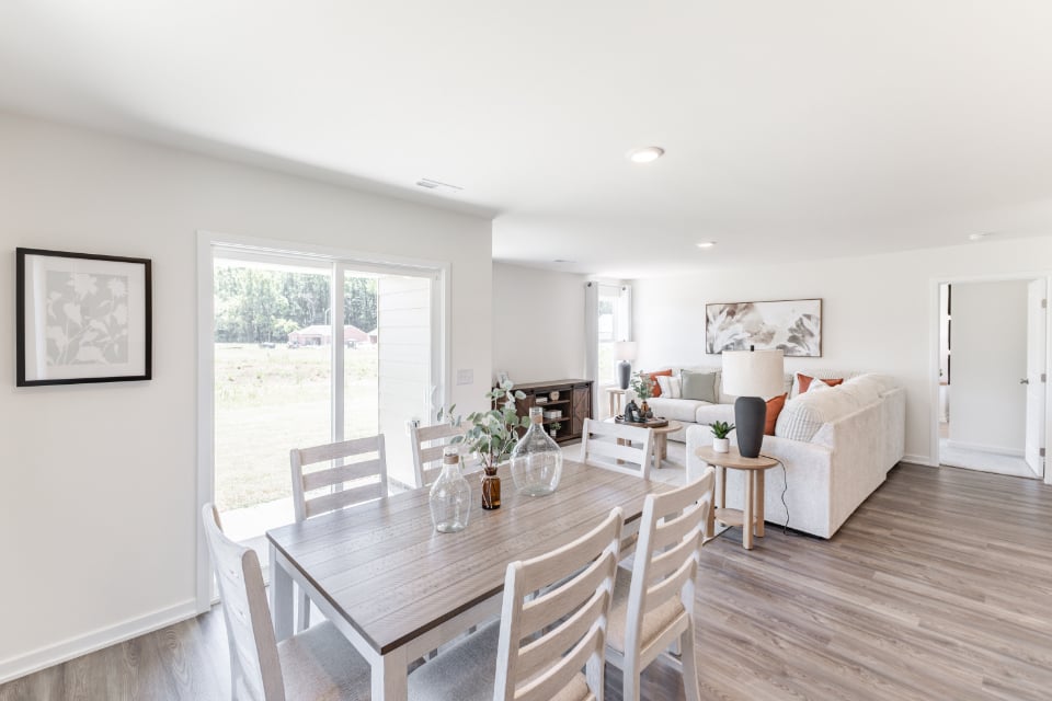 A dining room with a wood floor.