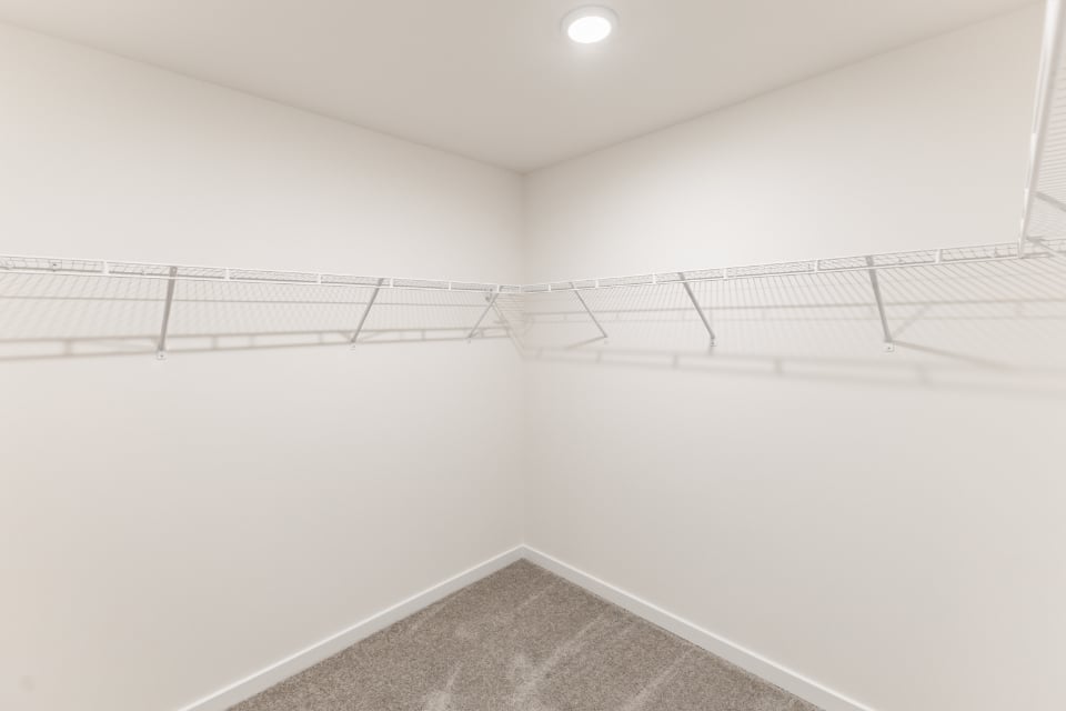 A white room with a metal railing.