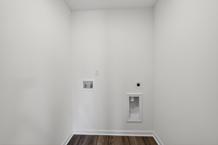 A white wall with a light switch.