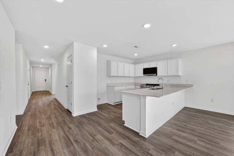 A kitchen with white cabinets.