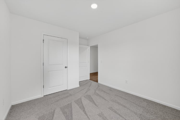 A hallway with white doors.