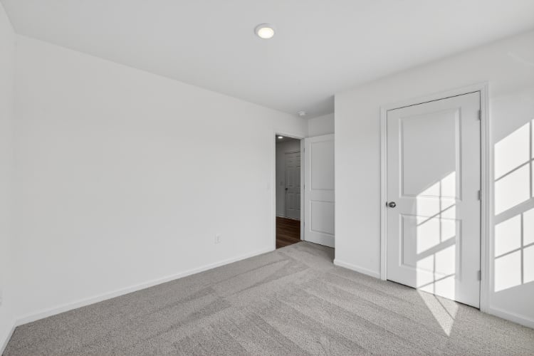 A hallway with white doors.
