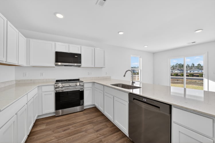 A kitchen with white cabinets.