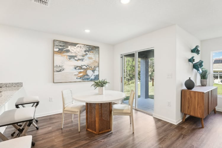A room with a table and chairs.
