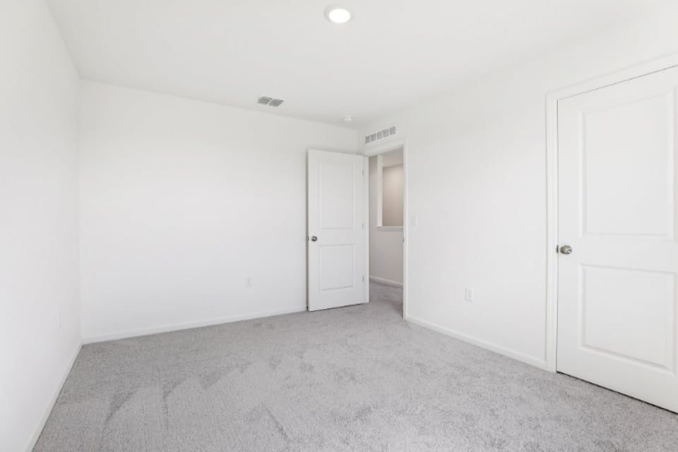 A hallway with white doors.