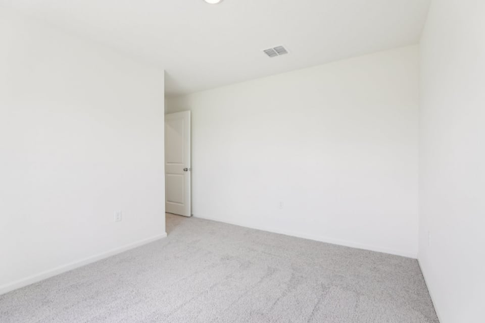 A hallway with white walls.