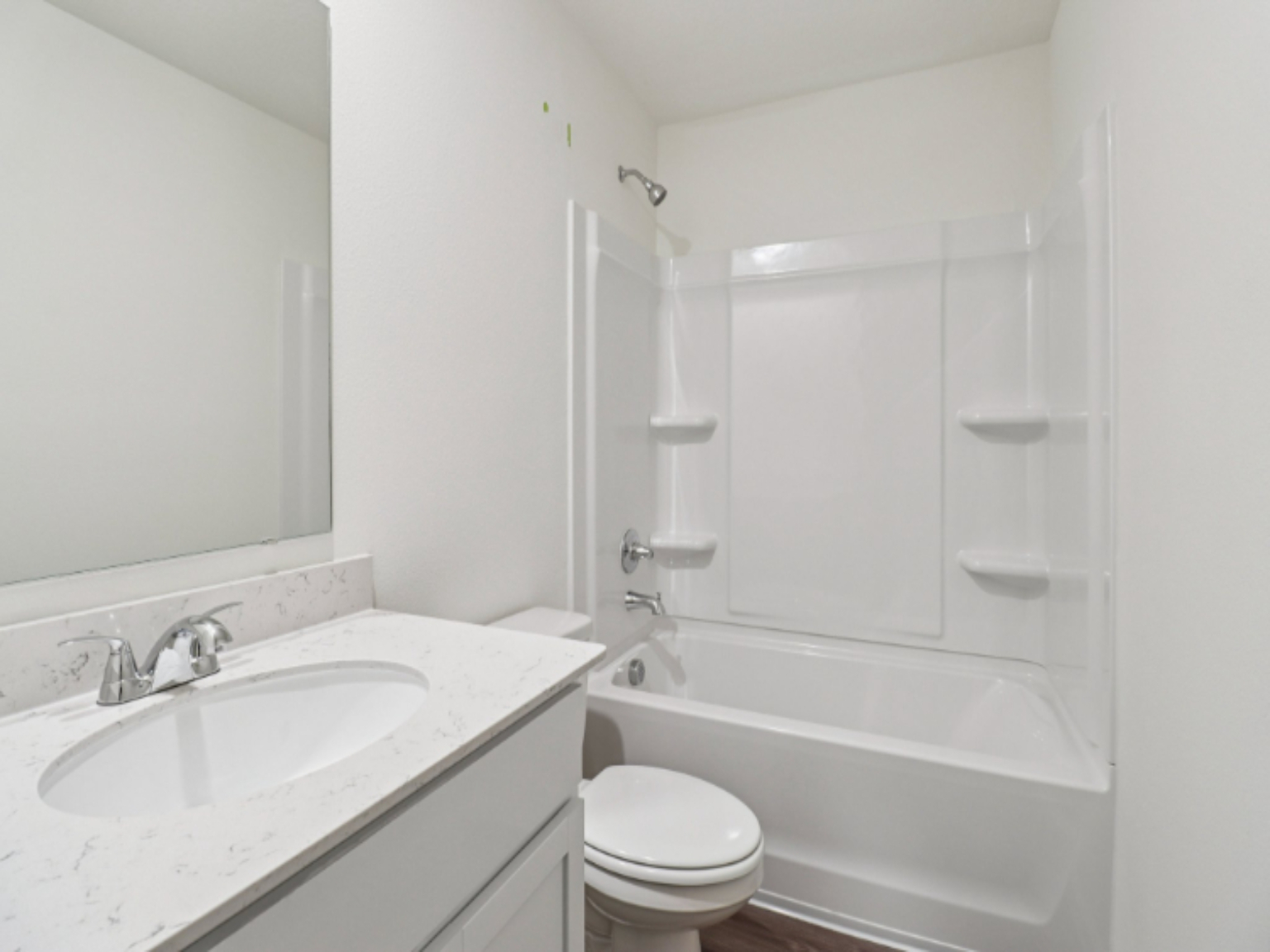 A bathroom with a tub sink and toilet.