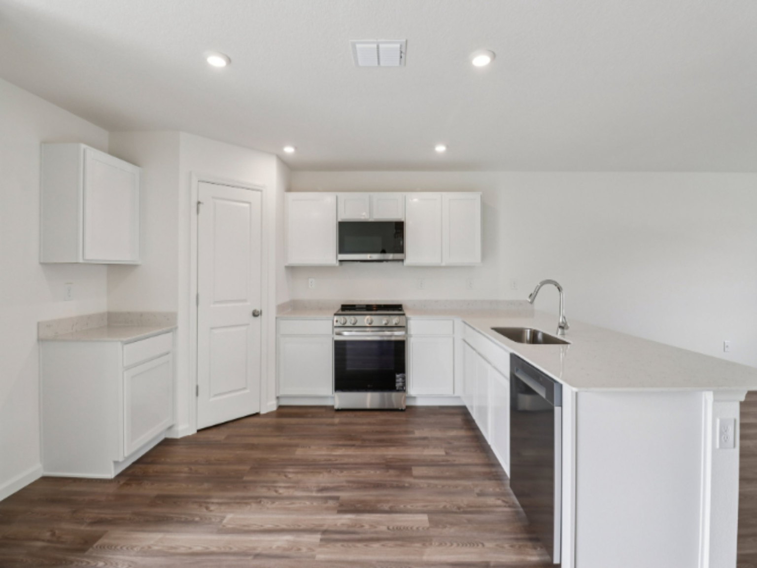 A kitchen with white cabinets.