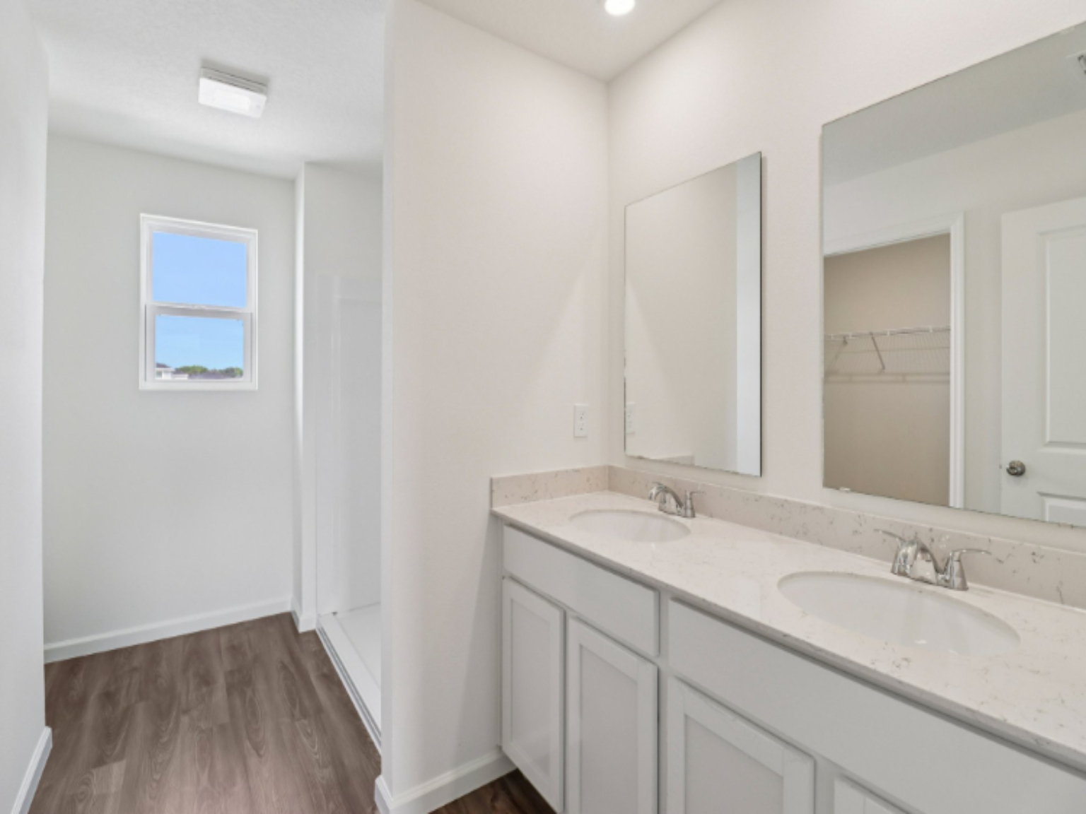 A bathroom with a large mirror.