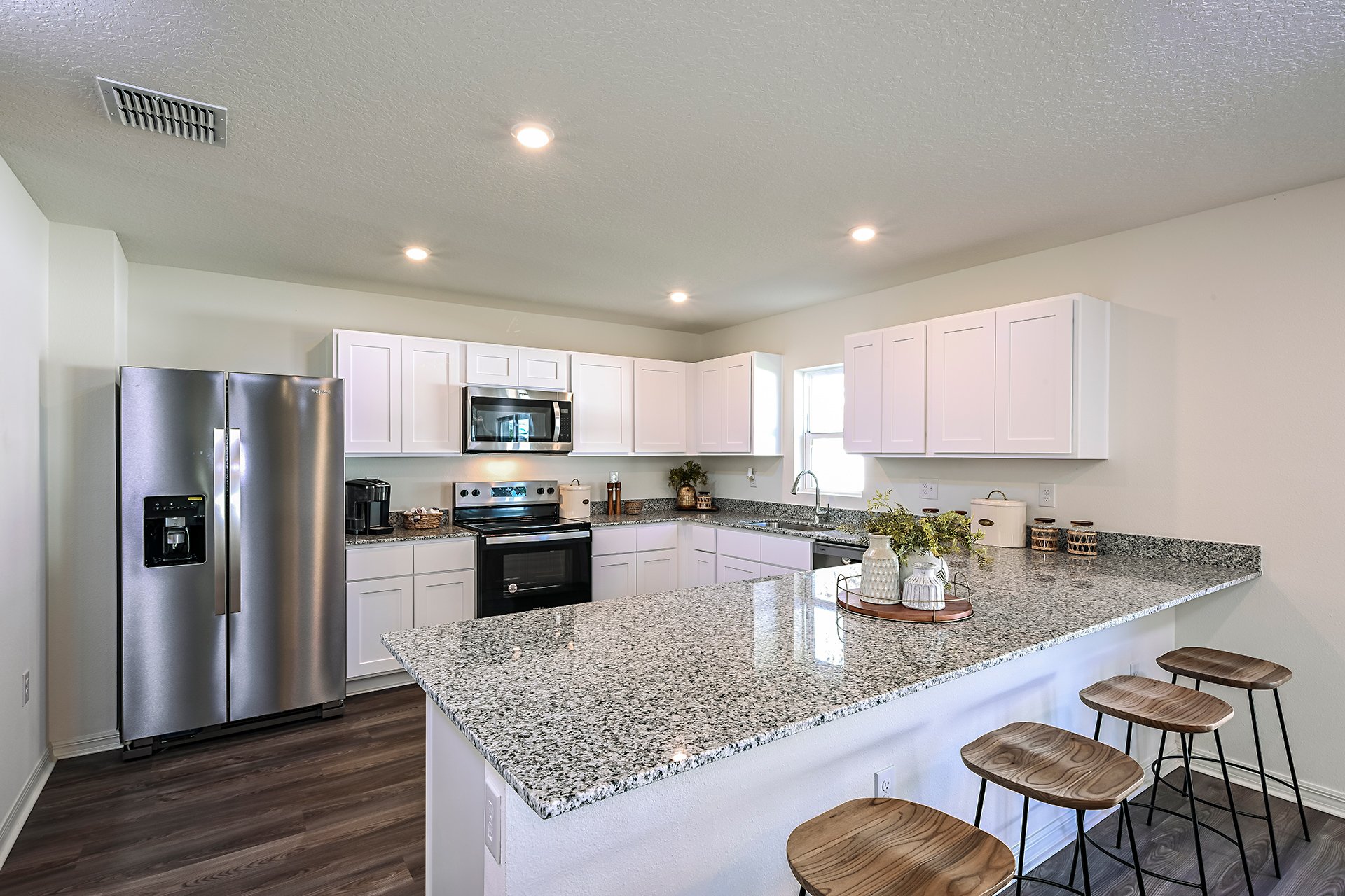 A kitchen with white cabinets.