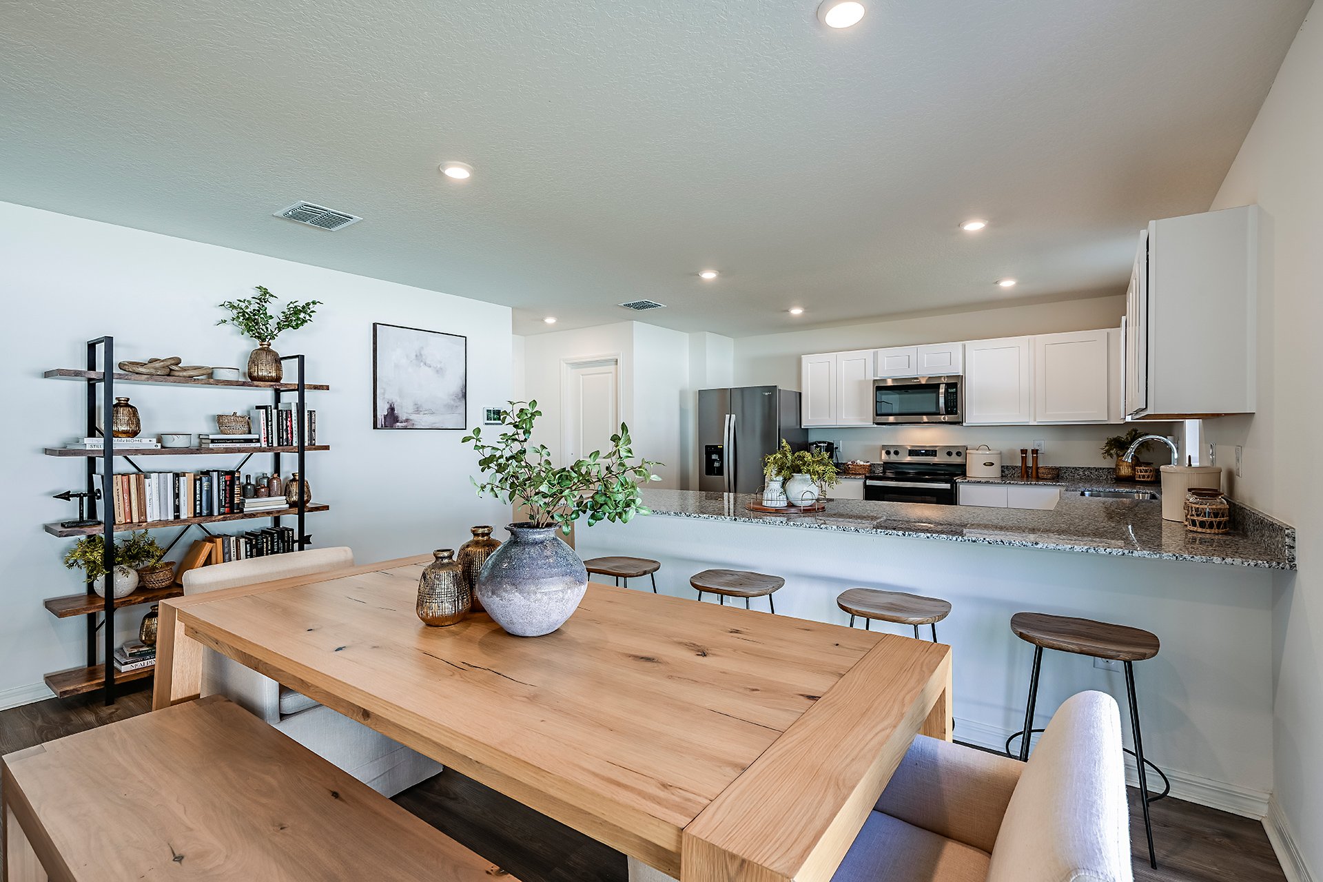 A kitchen with a table and chairs.