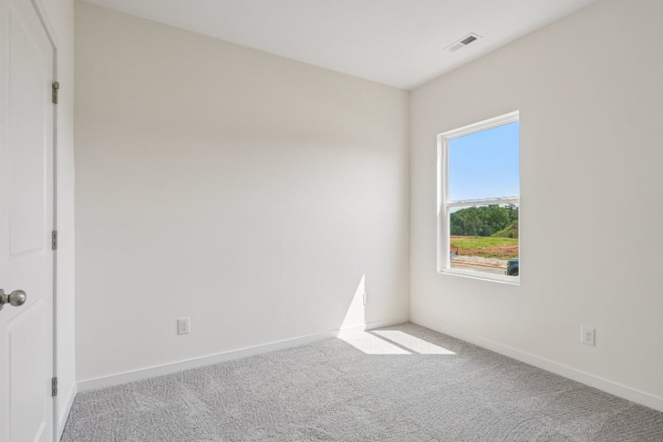A room with a window and a door.