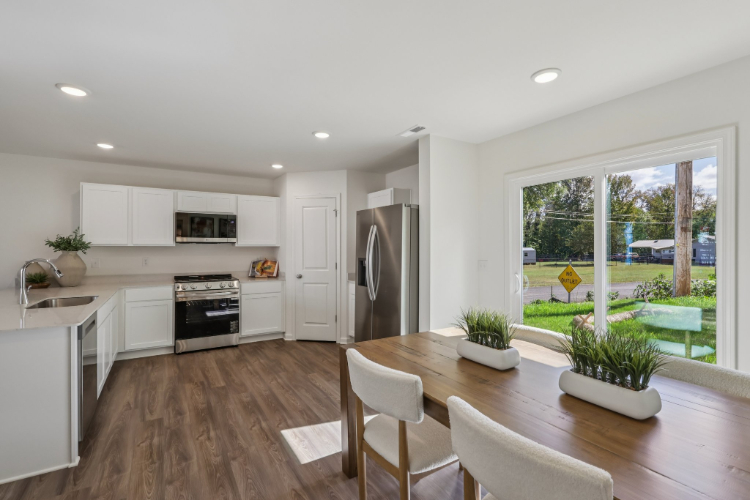 A kitchen with a table and chairs.