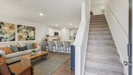 A living room with a staircase.
