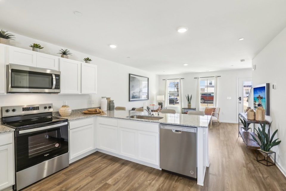 A kitchen with white cabinets.