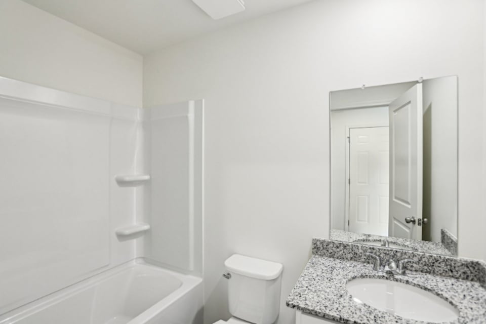A bathroom with a marble countertop.