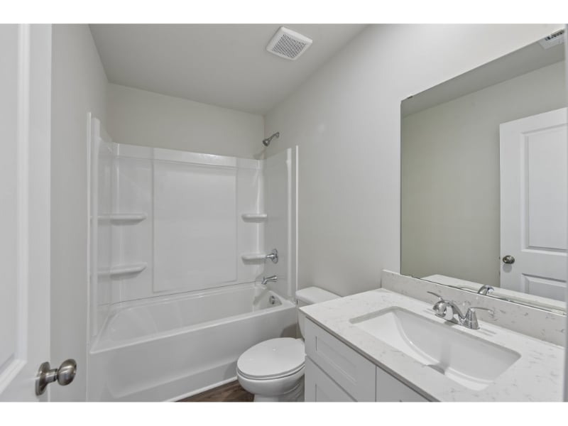 A bathroom with a sink toilet and bathtub.