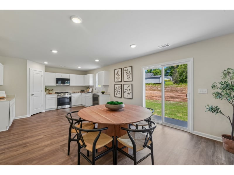 A kitchen with a dining table.