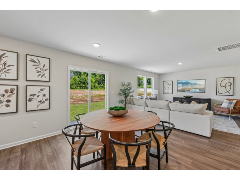 A living room with a table and chairs.